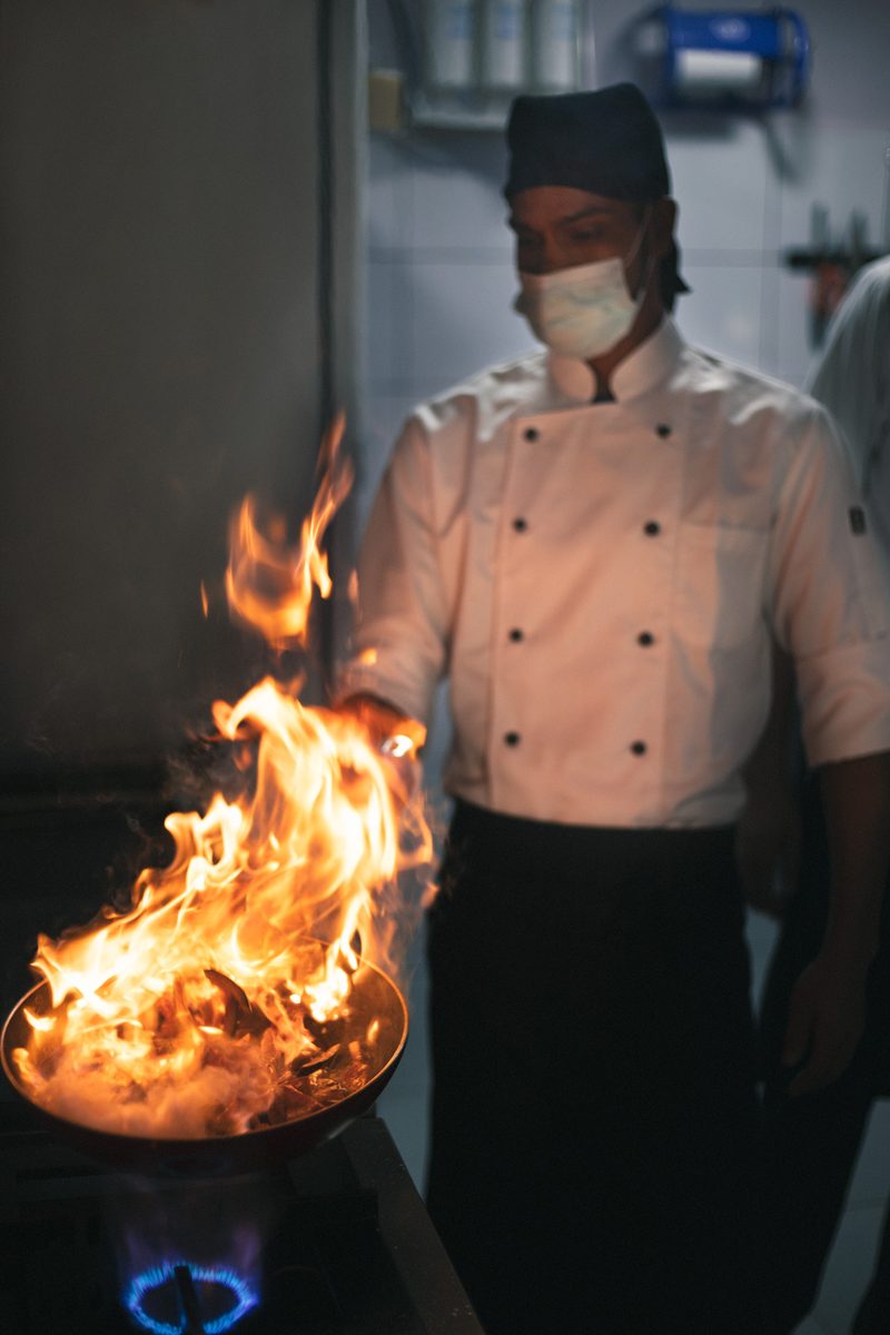 Chef Kenzo chef flambéing in the commercial kitchen