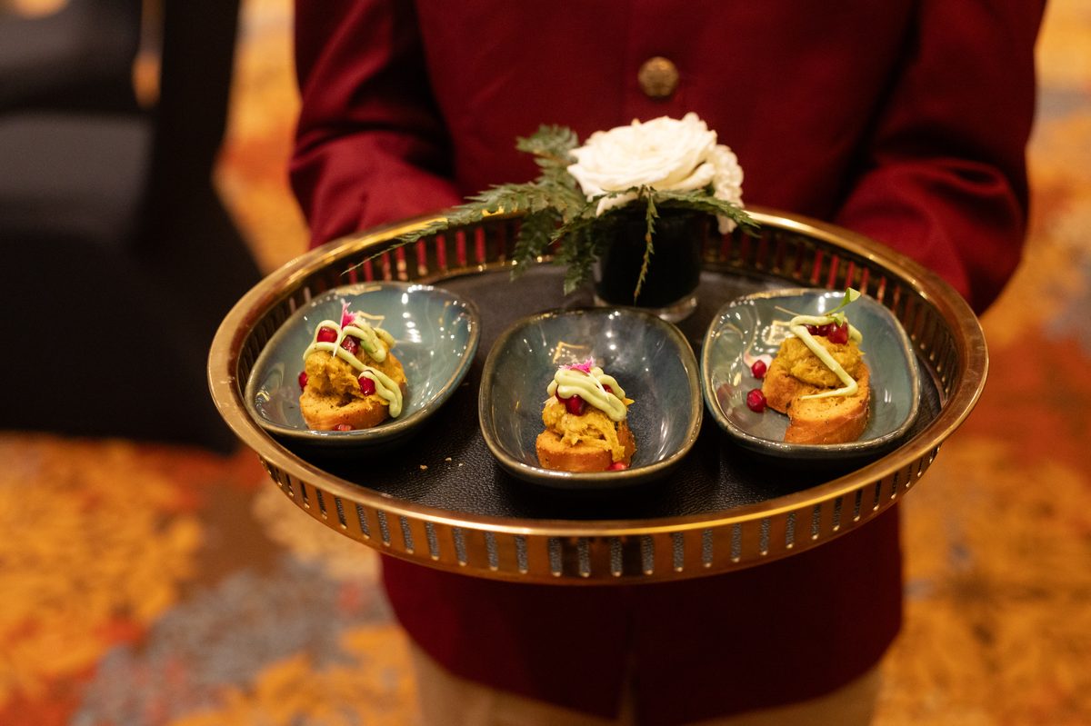 Luxury pass-around canapé service with mini tarts and fresh florals